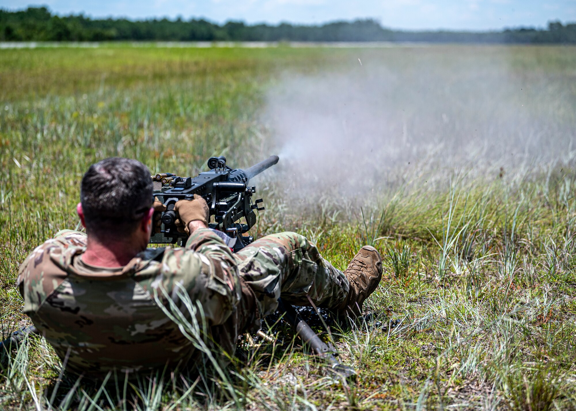 U.S. Air Force Col. Paul Sheets, 23rd Wing commander, fires an M2A1 machine gun at Moody Air Force Base, Georgia, July 12, 2024. Airmen from the 820th Combat Operations Squadron demonstrated the correct technique for operating the belt-fed machine gun to Sheets during the battlefield circulation (BFC). BFCs allow the base senior leaders to visit different units to learn about the work the Airmen do and get a true picture of how they operate in their day-to-day duties. (U.S. Air Force photo by Airman 1st Class Leonid Soubbotine)