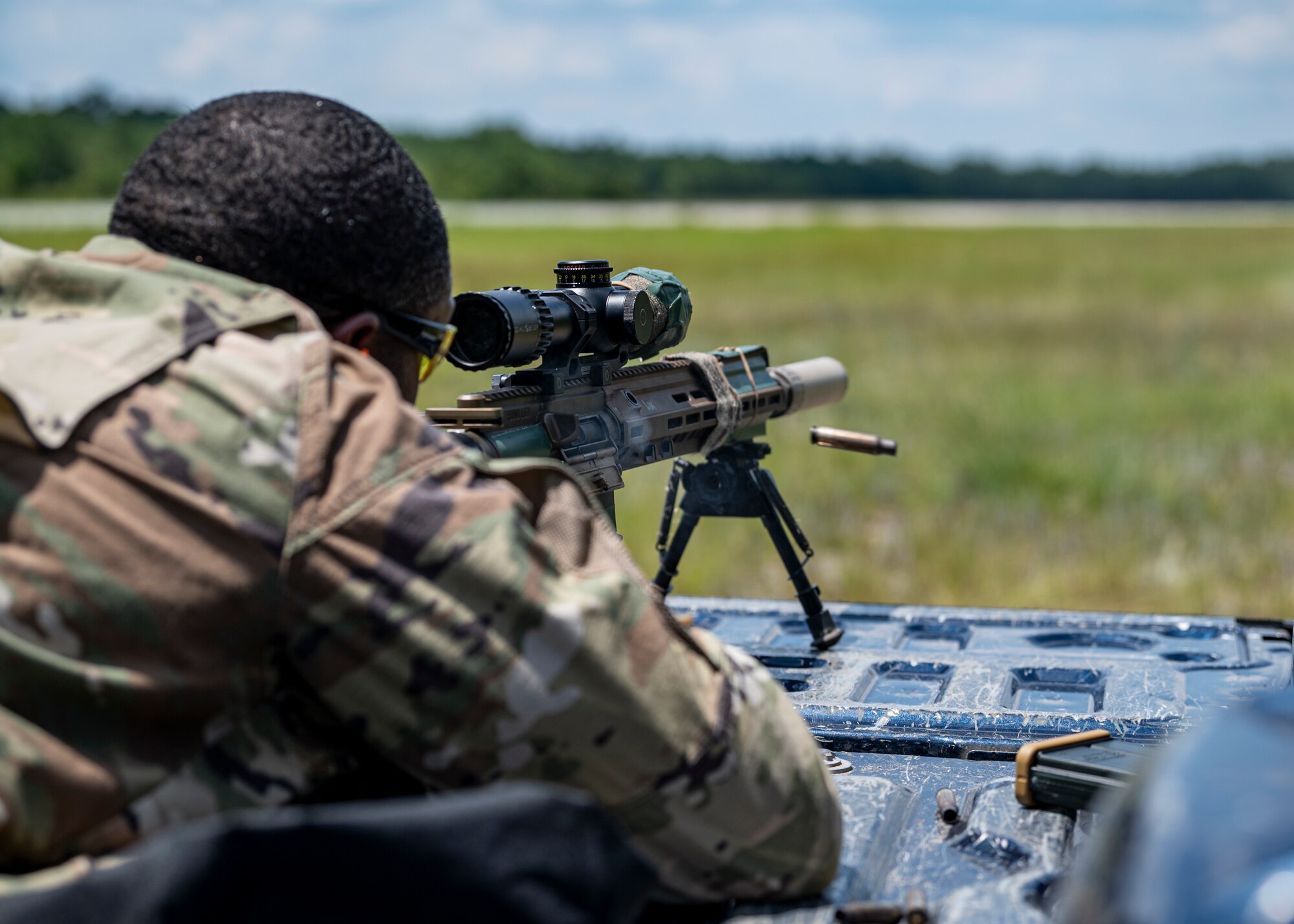 U.S. Chief Master Sgt. Harold Davis, 41st Rescue Generation Squadron senior enlisted leader, fires the M110A1 squad designated marksman rifle at Moody Air Force Base, Georgia, July 12, 2024. Davis was able to shoot the suppressed rifle at multiple static, and remote-controlled targets at various distances. Battlefield circulations allow the base senior leaders to visit different units to learn about the work the Airmen do and get a true picture of how they operate in their day-to-day duties. (U.S. Air Force photo by Airman 1st Class Leonid Soubbotine)