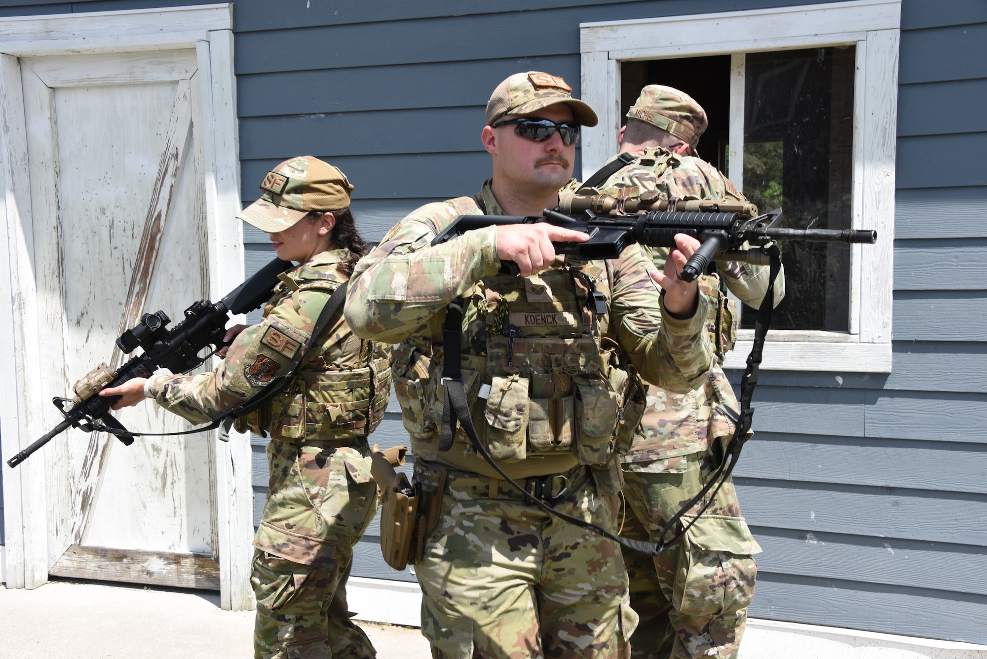 Airman Hope Sokolowski, 185th Air Refueling Wing Security Forces, left, Staff Sgt. Michael Koenck, 185th Air Refueling Wing Security Forces, center, and Staff Sgt. John Michel, 132nd Security Forces, right, practice approaching an entryway