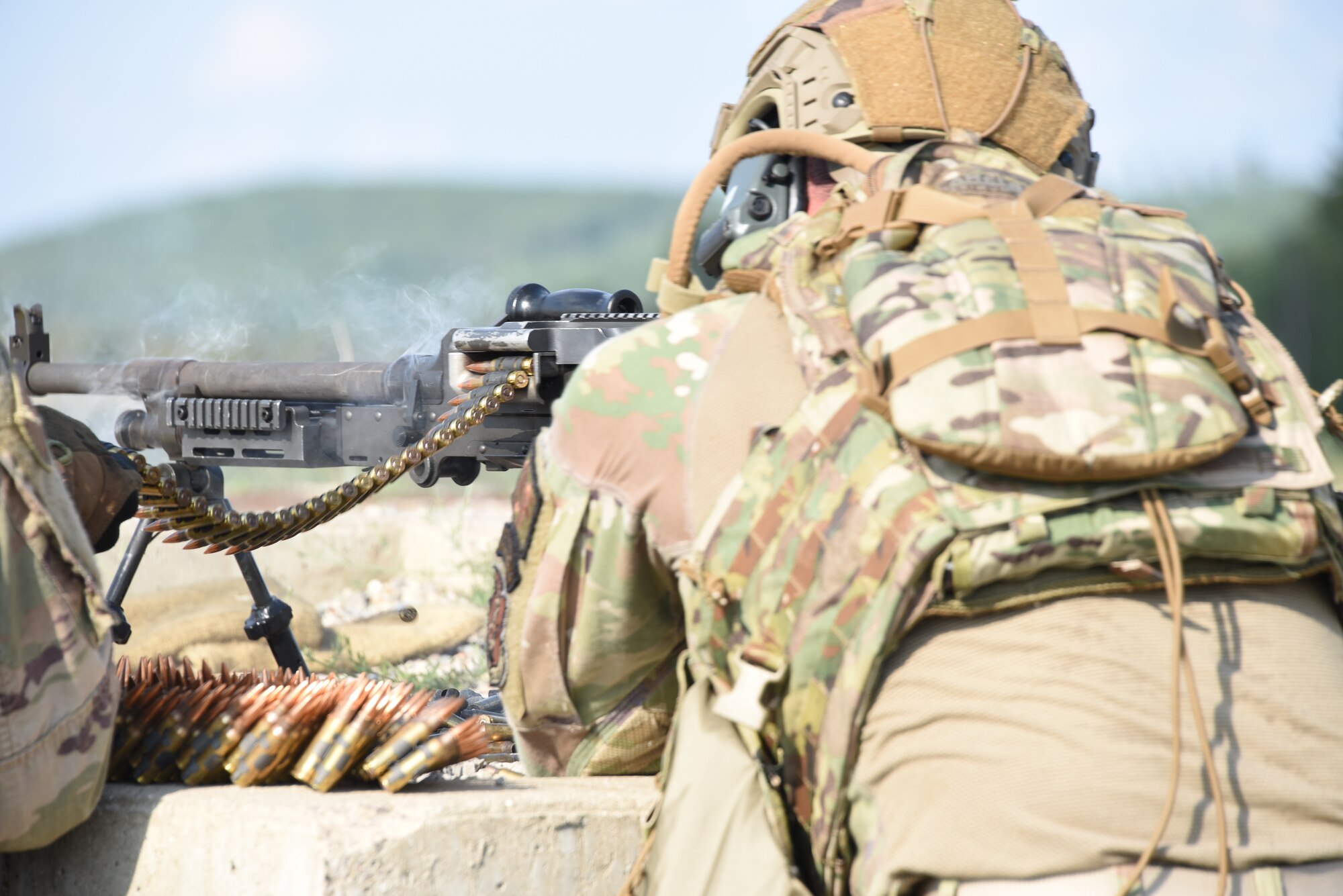 A U.S. Air National Guard Airman fires a M240B machine gun at a range