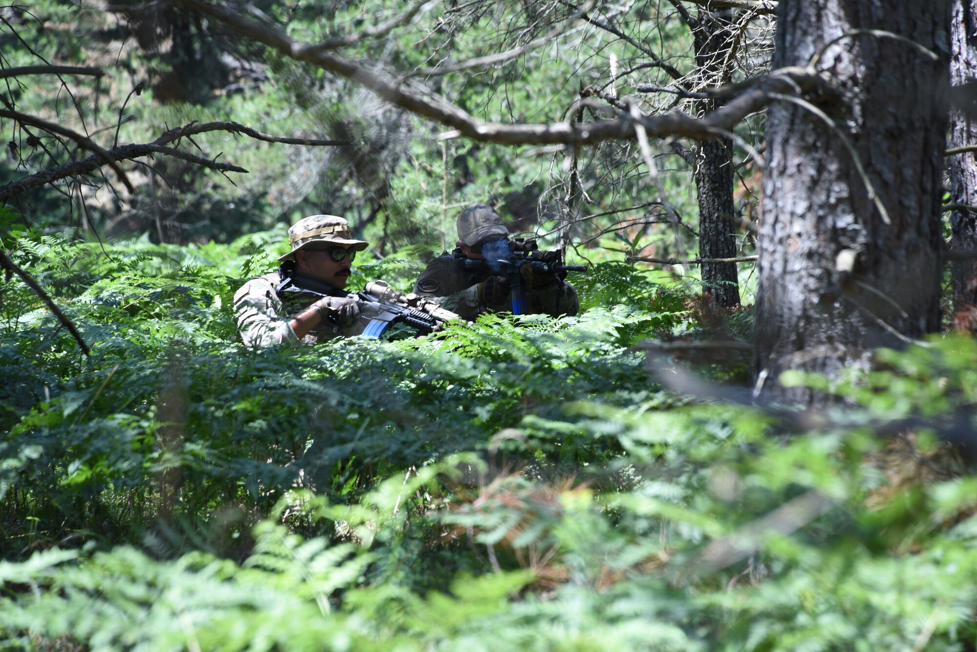 taff Sgt. Jakob Shattuck, a 185th Air Refueling Wing Combat Arms Instructor, left, and Senior Airman Parker Anderson, 132 Wind Security Forces, right, practice squad bounding techniques