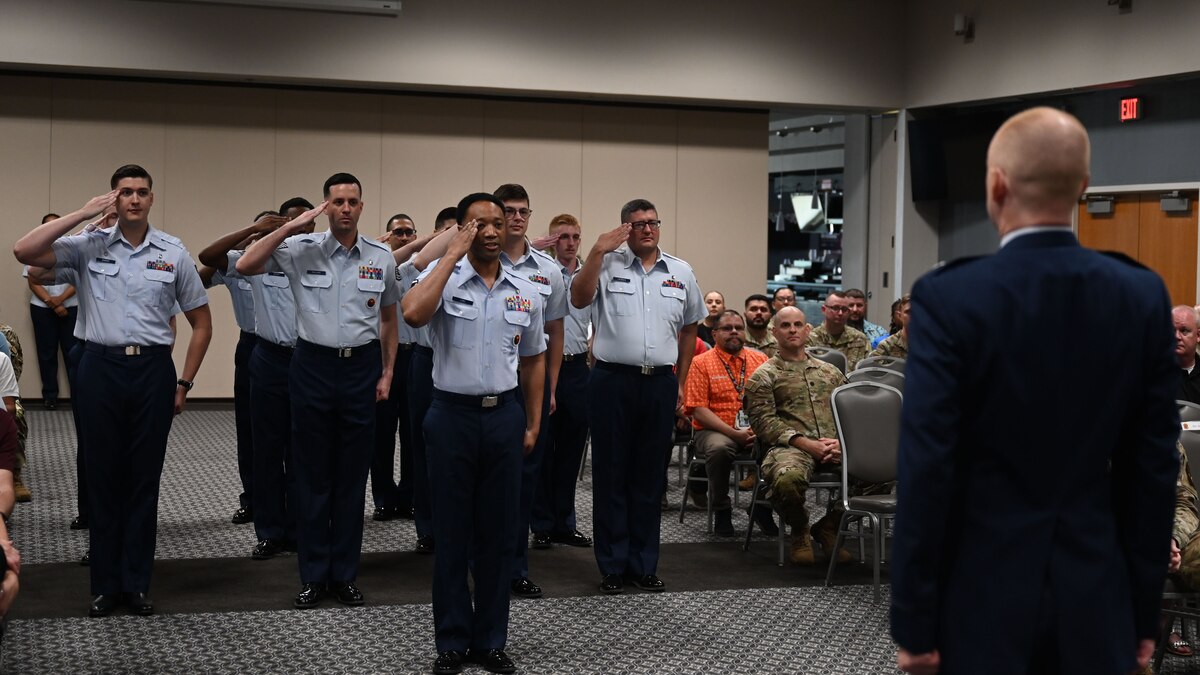 Members of the 17th Medical Group render the initial salute to U.S. Air Force Lt. Col. Justin Lusk, incoming 17th Healthcare Operations Squadron commander, during the change of command ceremony at the Powell Event Center, Goodfellow Air Force Base, Texas, July 12, 2024. The 17th HCOS is an engaged team committed to a healthy population that aims to provide trusted care every day. (U.S. Air Force photo by Senior Airman Zach Heimbuch)