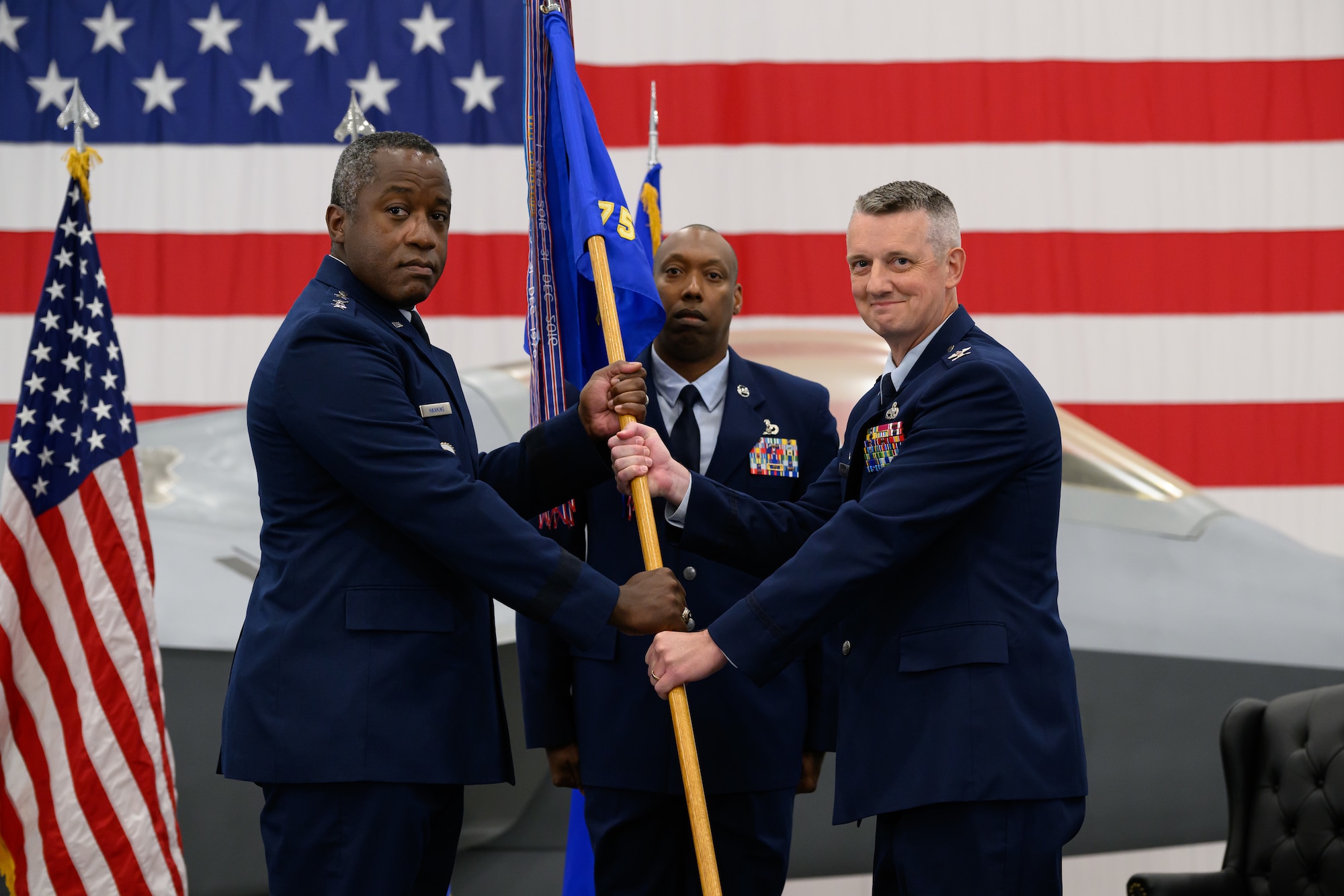Right, Col. Daniel L. Cornelius, incoming 75th Air Base Wing commander, receives the guidon from Lt. Gen. Stacey T. Hawkins, Air Force Sustainment Center commander, during a change of command ceremony July 16. The 75th ABW provides installation support for the Ogden Air Logistics Complex, two fighter wings, and 50 other mission partners. (U.S. Air Force photo by R. Nial Bradshaw)
