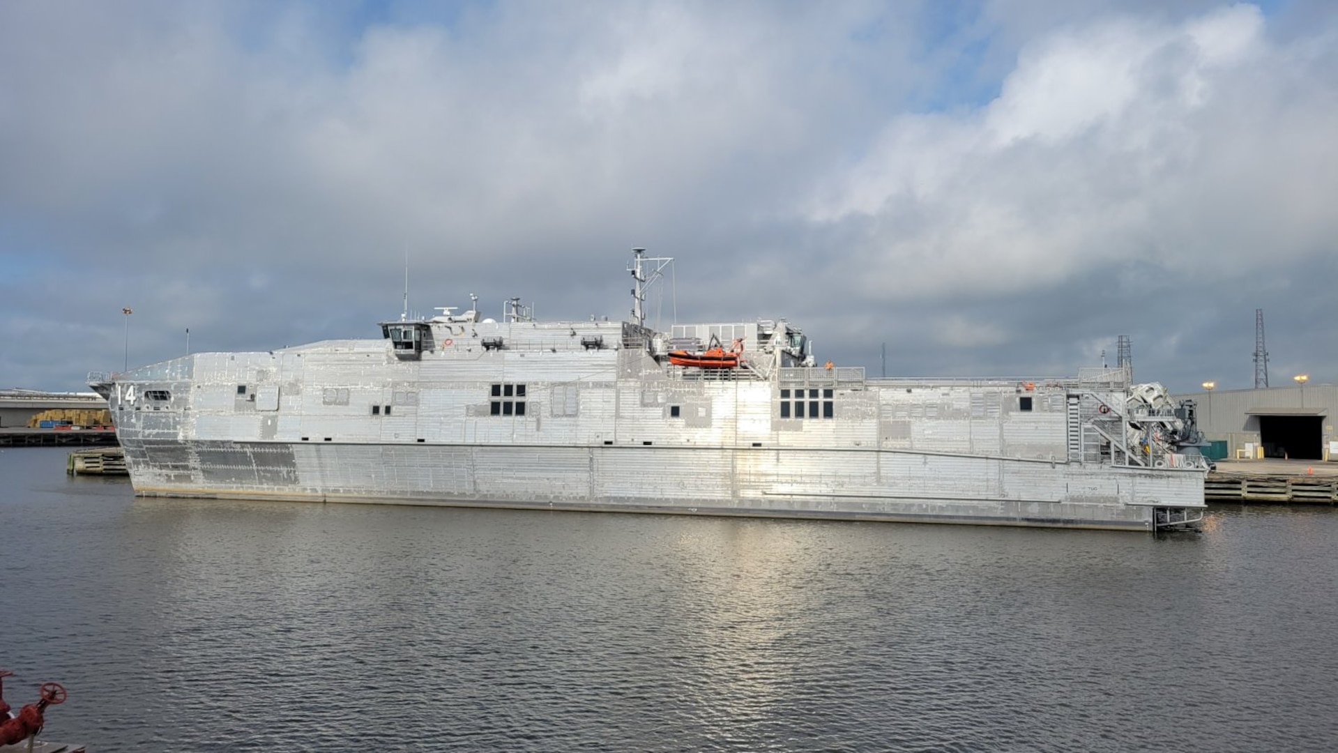 SNS Cody (T-EPF 14) moored pier side in the harbor at Austal USA’s shipyard in Mobile, Alabama.