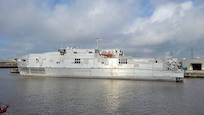 SNS Cody (T-EPF 14) moored pier side in the harbor at Austal USA’s shipyard in Mobile, Alabama.