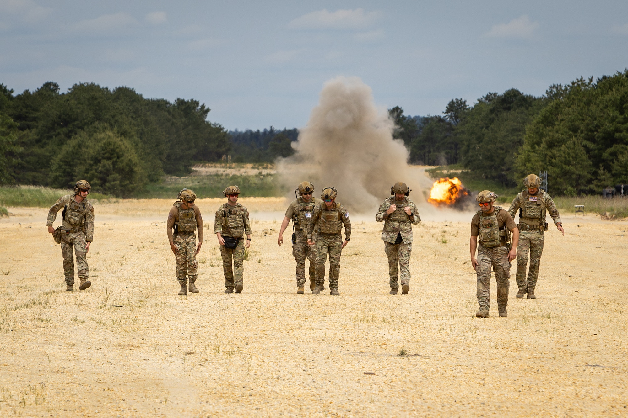 Members of the 177th Civil Engineers Squadron EOD team, 177th Fighter Wing, New Jersey Air National Guard, and personnel of the 70th Combat Engineer Battalion of the National Guard of the Republic of Cyprus walk away from C4 explosives detonating at Warren Grove Range, New Jersey, Apr. 13, 2024.