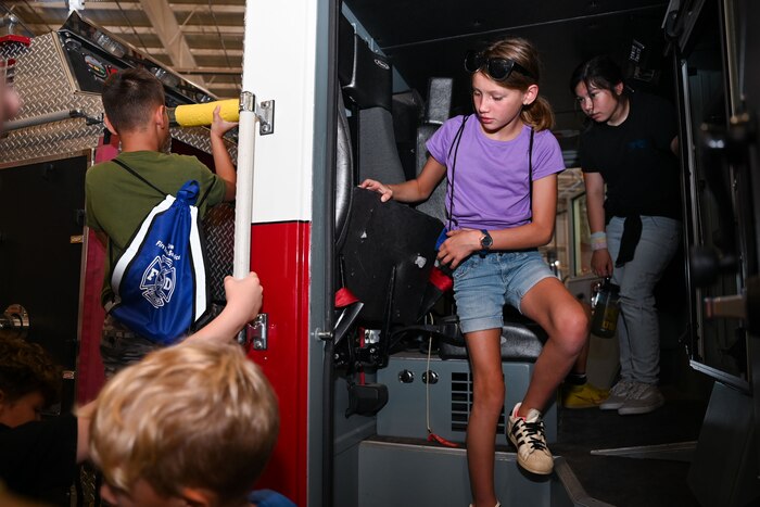Junior firefighter students tour a firetruck during the fifth day of the 2024 Junior Firefighter Camp at the Louis F. Garland Department of Defense Fire Academy, Goodfellow Air Force Base, Texas, July 12, 2024. Students participated in a tour of various training components conducted there, followed by a graduation ceremony for the junior firefighters. (U.S. Air Force photo by Airman 1st Class Evelyn J. D’Errico)
