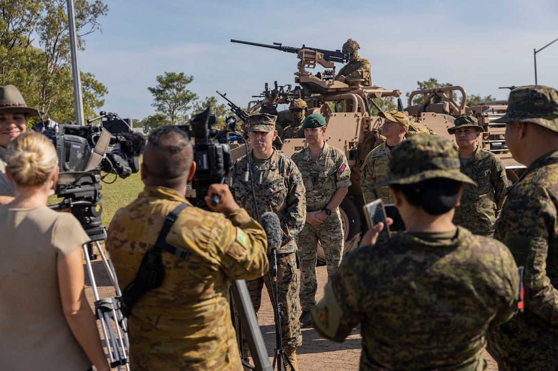 Service members from the United States, Australia, the Republic of the Philippines, and the United Kingdom, participate in media interviews after the opening ceremony of Exercise Predator’s Run 24 at Robertson Barracks, NT, Australia, July 15, 2024. Exercise Predator’s Run 24 is a littoral-focused, multilateral training exercise led by the Australian Army’s 1st Brigade, involving the Australian Defence Force, British Armed Forces, and the U.S. Marine Corps. Marine Rotational Force – Darwin 24.3’s participation in Exercise Predator’s Run 24 increases interoperability with Allies and partners, highlighting the effectiveness of combined operations. (U.S. Marine Corps photo by Sgt. Cristian Bestul)