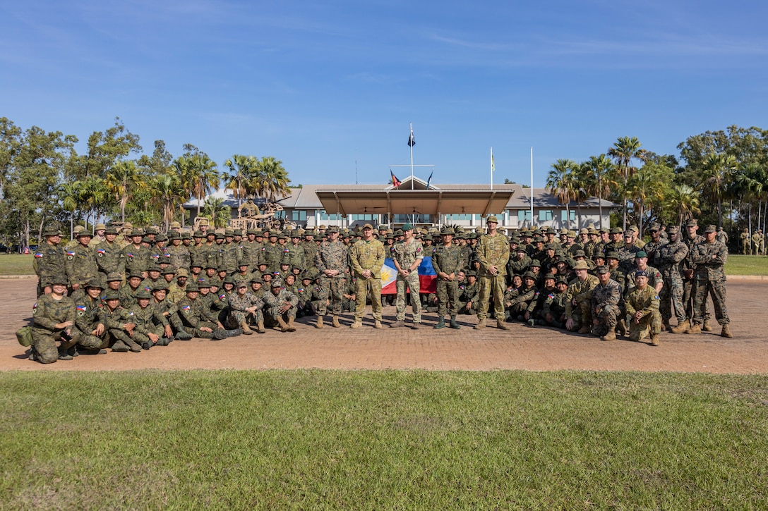 Service members from the United States, Australia, the Republic of the Philippines, and the United Kingdom, pose for a photo after the opening ceremony of Exercise Predator’s Run 24 at Robertson Barracks, NT, Australia, July 15, 2024. Exercise Predator’s Run 24 is a littoral-focused, multilateral training exercise led by the Australian Army’s 1st Brigade, involving the Australian Defence Force, British Armed Forces, and the U.S. Marine Corps. Marine Rotational Force – Darwin 24.3’s participation in Exercise Predator’s Run 24 increases interoperability with Allies and partners, highlighting the effectiveness of combined operations. (U.S. Marine Corps photo by Sgt. Cristian Bestul)