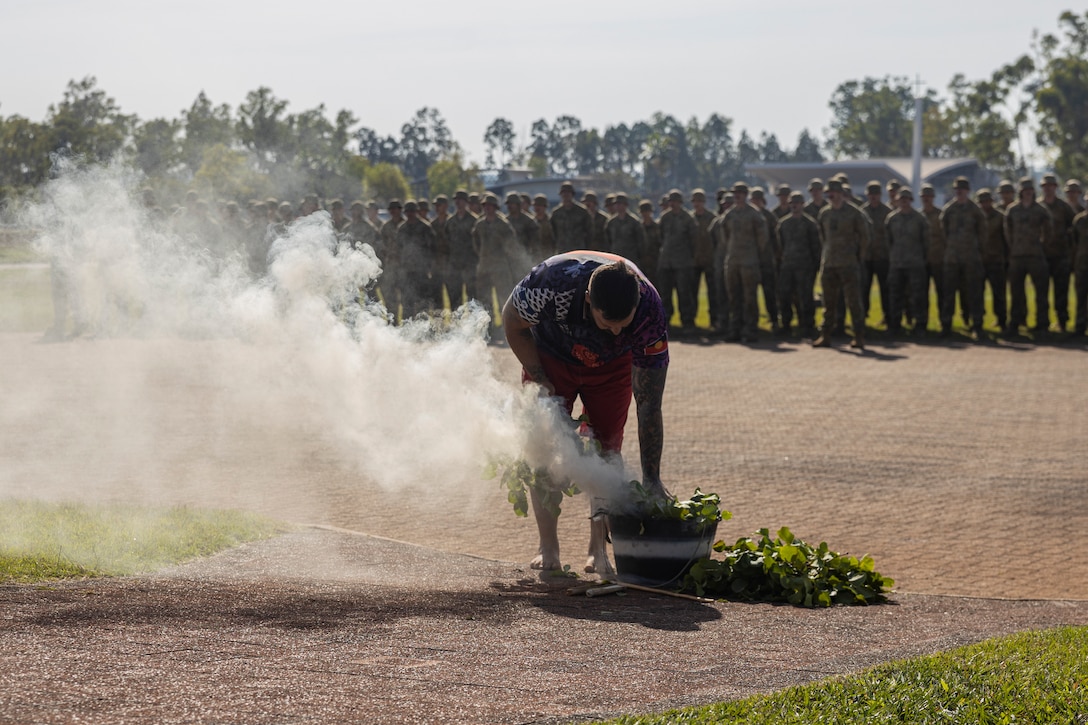 An Elder from the Larrakia People begins a smoking ceremony during the opening ceremony of Exercise Predator’s Run 24 at Robertson Barracks, NT, Australia, July 15, 2024. Exercise Predator’s Run 24 is a littoral-focused, multilateral training exercise led by the Australian Army’s 1st Brigade, involving the Australian Defence Force, British Armed Forces, and the U.S. Marine Corps. Marine Rotational Force – Darwin 24.3’s participation in Exercise Predator’s Run 24 increases interoperability with Allies and partners, highlighting the effectiveness of combined operations. (U.S. Marine Corps photo by Sgt. Cristian Bestul)