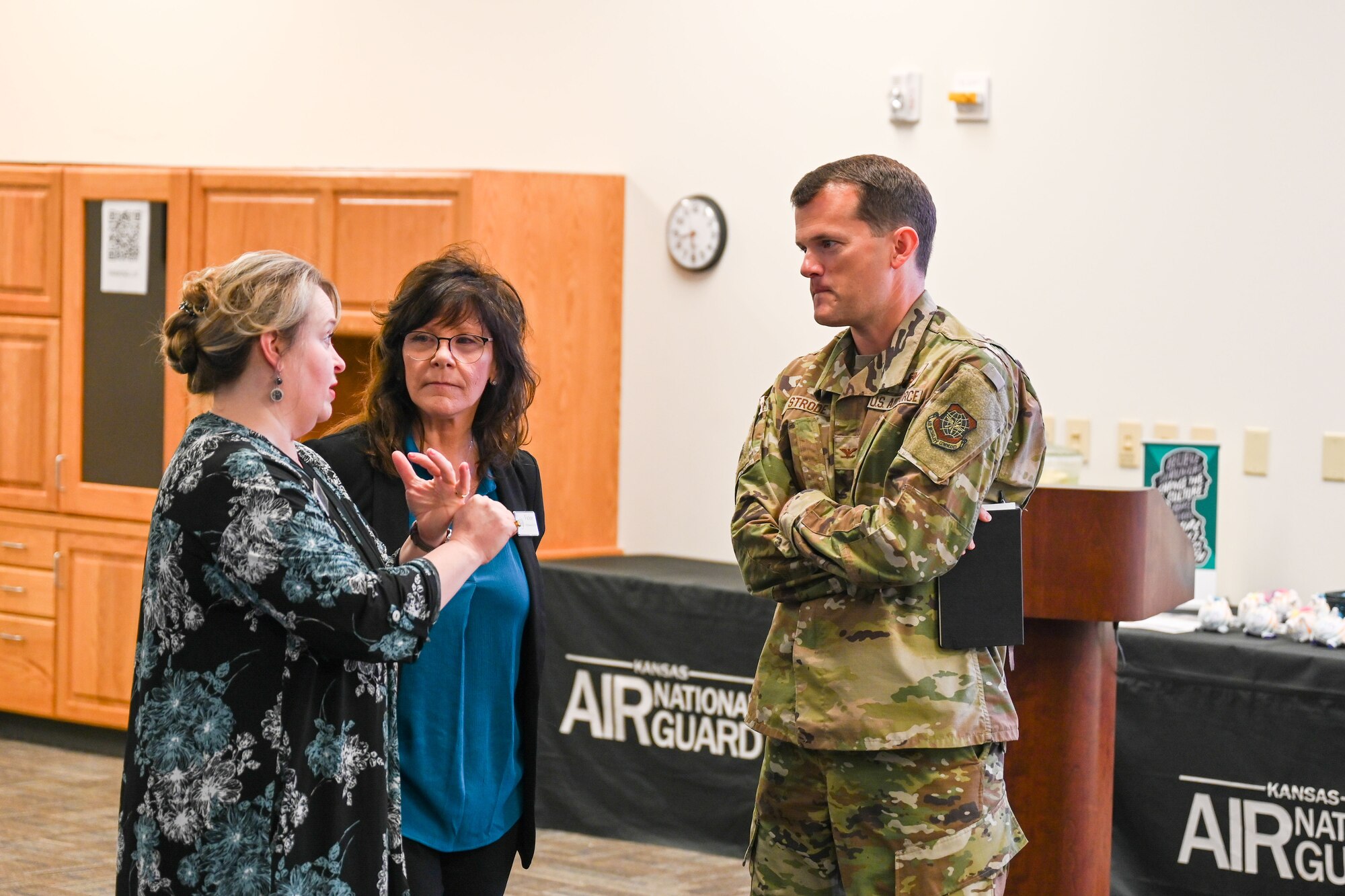 Camren Schott, Air Mobility Command sexual assault response program manager, Vickie Hayden, 22nd Air Refueling Wing sexual assault program manager and Col. Aaron Strode, 22nd Air Refueling Wing deputy commander, have a conversation at the beginning of sexual assault prevention week July 9, 2024, at McConnell Air Force Base, Kansas. SARCs and victim advocates meet for teambuilding and refresher training, allowing them to network and train to better help victims of sexual assault.