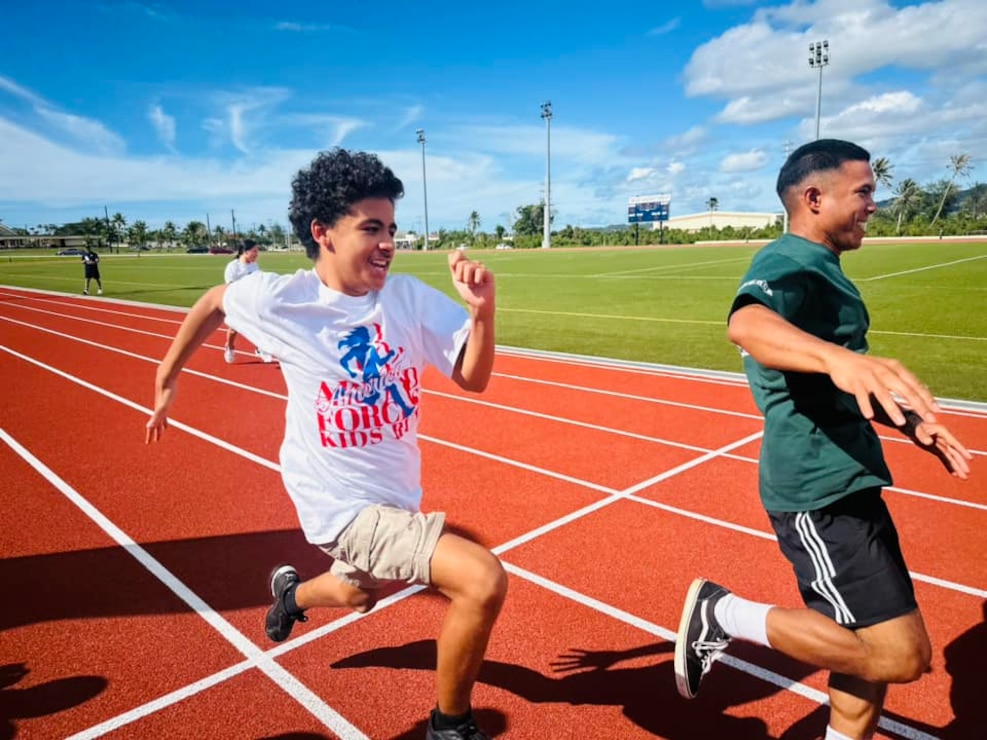 NAVAL BASE GUAM (May 31, 2024) - Youth from U.S. Naval Base Guam participate in a a ceremonial race during the reopening of the Charles King Fitness Center Track and Field, May 31. The $4.9 million contract included the removal of the damaged track, repair of the aggregate base course and drainage, new asphalt pavement, a new synthetic surfacing system, and a new electronic wireless scoreboard.