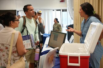 JOINT BASE PEARL HARBOR-HICKAM, Hawaii (July 9, 2024) A community liaison officer for Navy Closure Task Force-Red Hill (NCTF-RH) shares information on the Extended Drinking Water Monitoring (EDWM) plan and Water Quality Action Team (WQAT) at the Hickam Chapel on Joint Base Pearl Harbor-Hickam (JBPHH), Hawaii, July 9, 2024. The Navy voluntarily instituted the EDWM and WQAT programs in April 2024 following the end of the two-year drinking water Long-Term Monitoring program. The programs are designed to provide resources and enhanced water sampling and testing for residents on the JBPHH drinking water system. (U.S. Navy photo by Mass Communication Specialist Seaman Krystal Diaz)