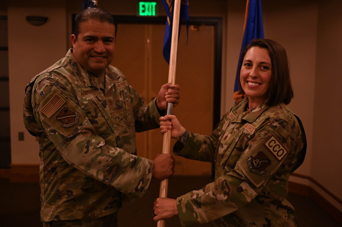 Col. Antonio Alvarado, hands the guidon symbolizing command to Maj. Jessica Zillinger.