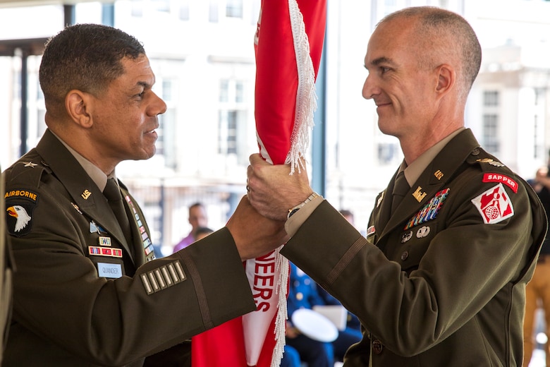 Maj. Gen. Mark Quander, commander of the U.S. Army Corps of Engineers (USACE), Great Lakes and Ohio River Division, passes the USACE Detroit District colors to its new commander Lt. Col. Wallace Bandeff, during a Change of Command ceremony at The War Memorial in Grosse Pointe Farms, Michigan on July 16. Lt. Col. Bandeff, a Michigan native, is serving in his fourth USACE tour of duty after previously serving as the Walla Walla District deputy commander. (U.S. Army Corps of Engineers photo by Brandon Hubbard)