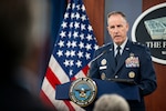 A person speaks from a podium.