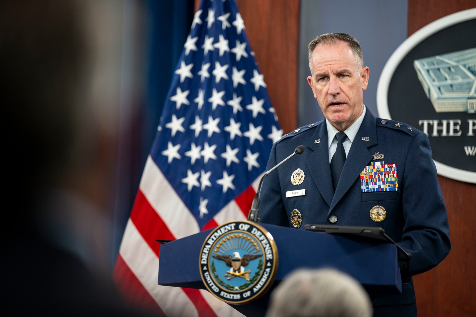 A person speaks from a podium.