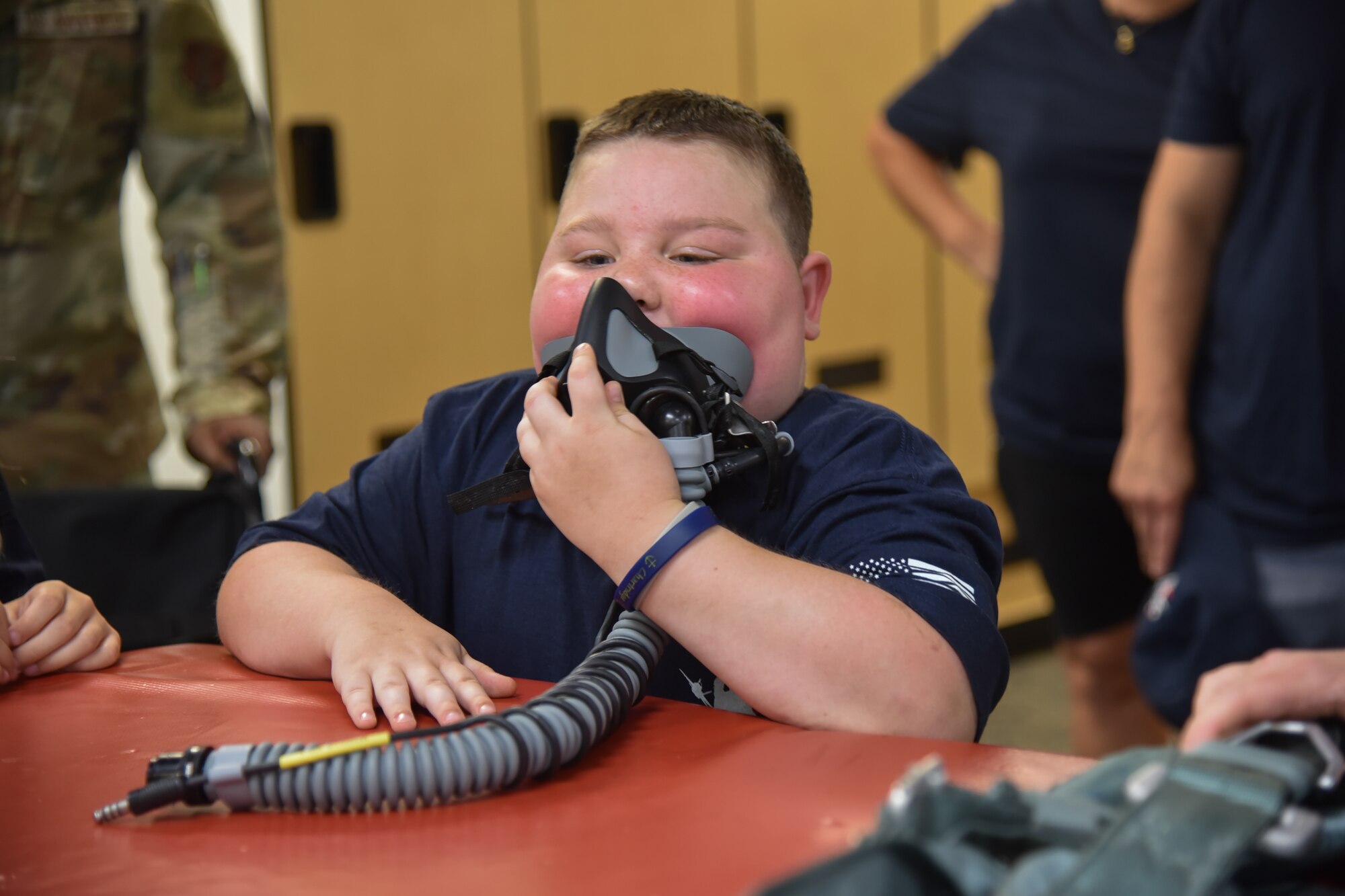 Child tries on f-16 oxygen mask