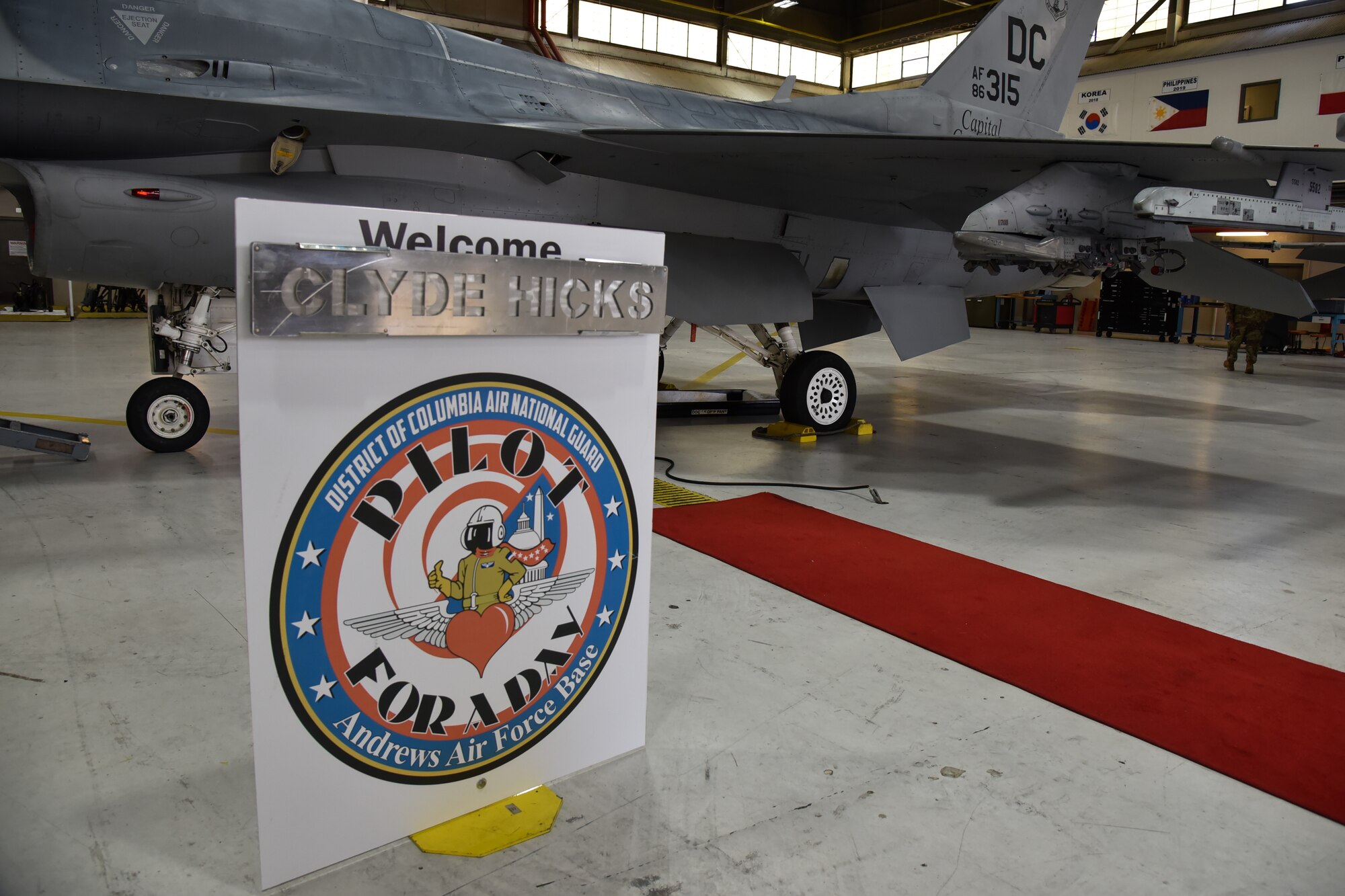 A sign in front of an f-16.