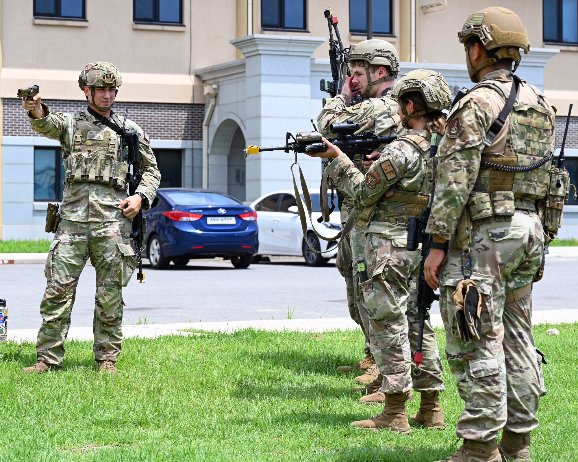 Senior Airman Cooper Pence, left, 8th Security Forces Squadron response force leader, instructs fellow defenders on weapon manipulation drills during exercise Beverly Sentinel 24-2 at Kunsan Air Base, Republic of Korea