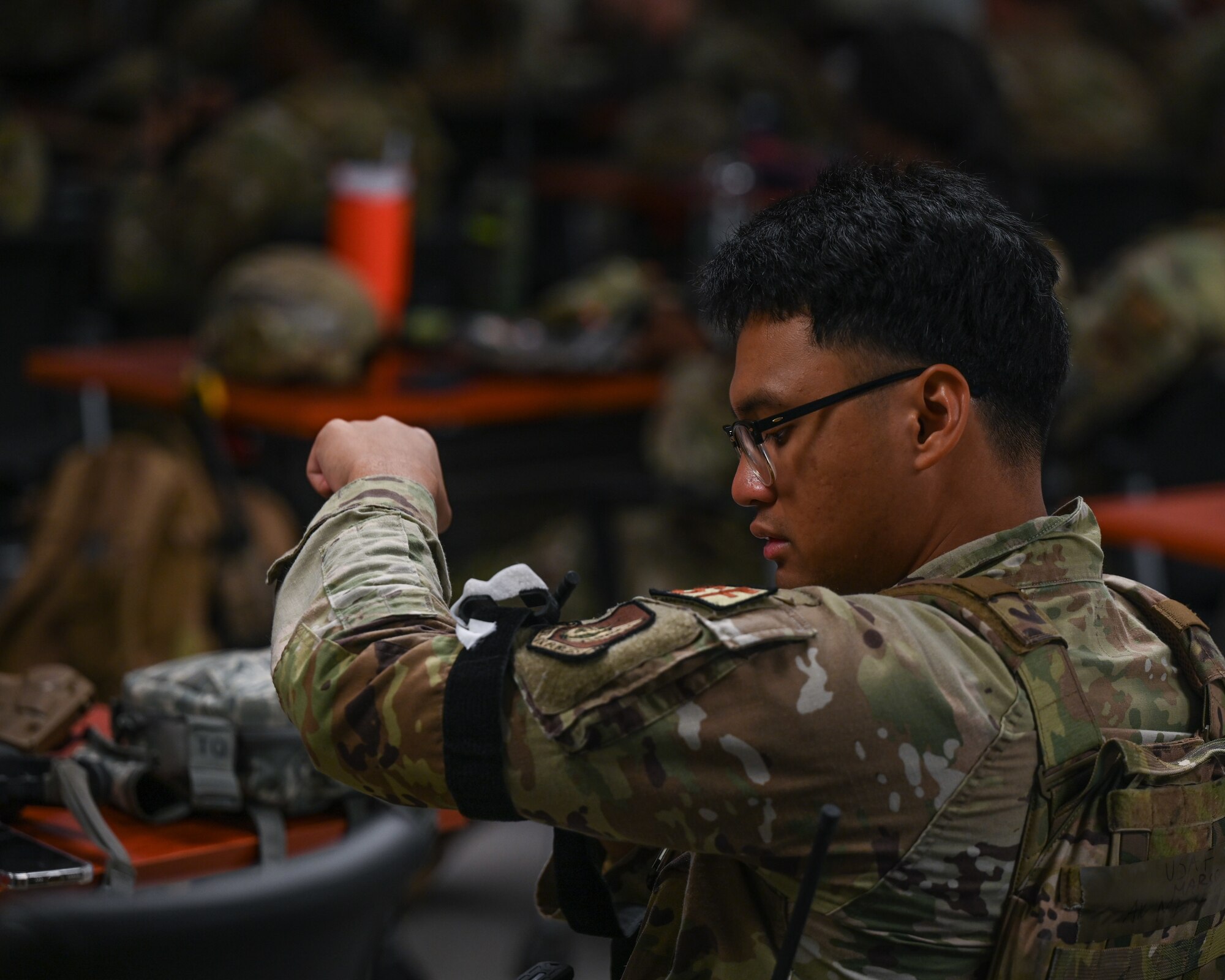 Airman 1st Class Marco Meneses, 8th Security Forces Squadron installation entry controller, applies a tourniquet to himself during a tactical combat casualty care course as part of exercise Beverly Sentinel 24-2 at Kunsan Air Base, Republic of Korea
