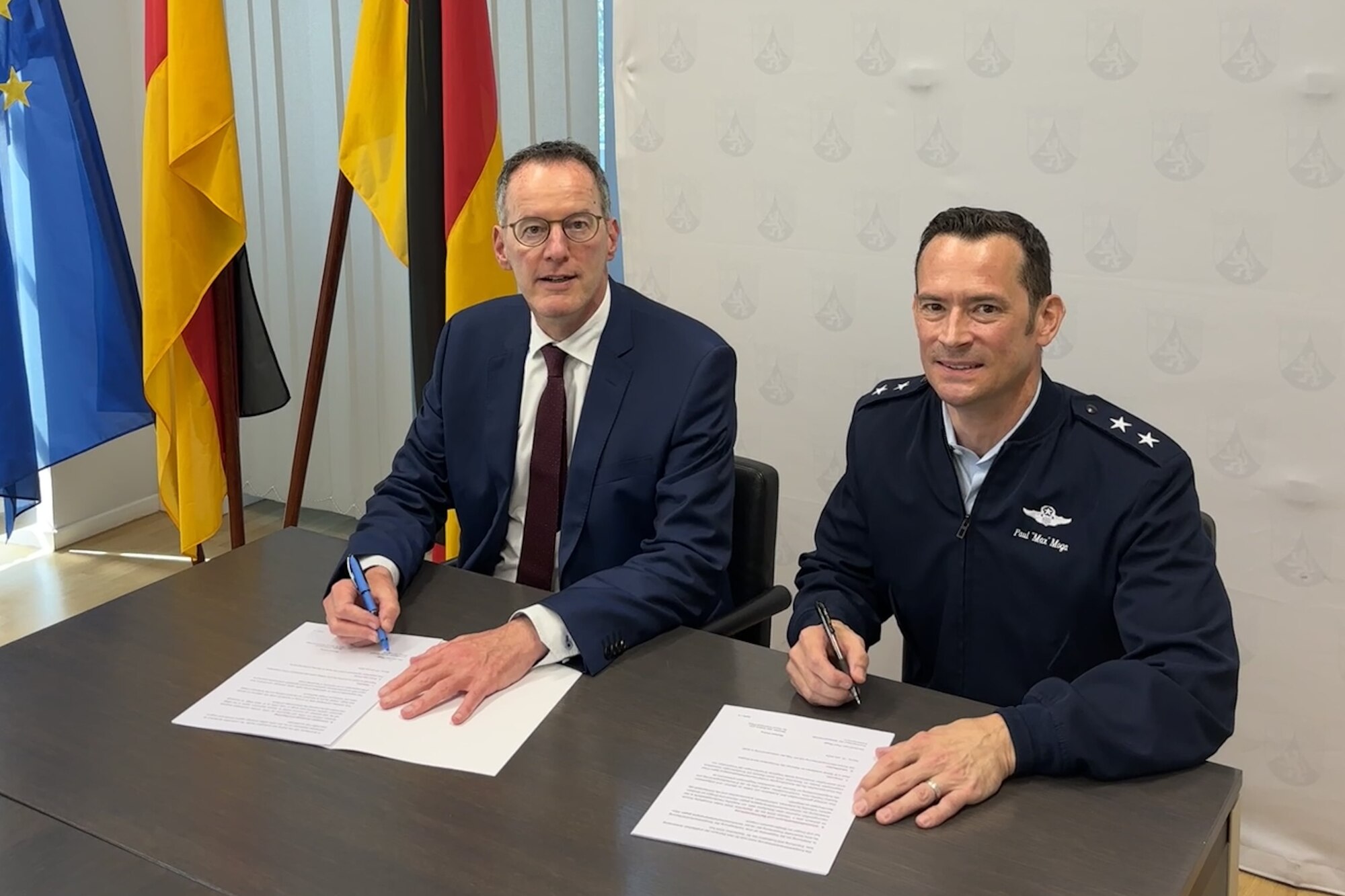 Maj. Gen. Paul D. Moga, Third Air Force and Kaiserslautern Military Community commander, and Michael Ebling, State Minister of the Interior of Rhineland-Palatinate, sign a cooperation agreement establishing a partnership between the KMC and the Police Presidium West Palatinate with the aim of preventing and reducing DUI offenses in the area July 15, 2024.