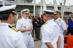 240717-N-WM182-1035 PORT KLANG, Malaysia (July 17, 2024) Vice Adm. Fred Kacher (center), commander, U.S. 7th Fleet, is greeted by senior members of the Royal Malaysian Navy following the arrival of the 7th Fleet flagship USS Blue Ridge (LCC 19) in Port Klang, Malaysia, July 17, 2024. 7th Fleet is the U.S. Navy's largest forward-deployed numbered fleet, and routinely interacts and operates with allies and partners in preserving a free and open Indo-Pacific region. (U.S. Navy Photo by Mass Communication Specialist 2nd Class Caitlin Flynn)