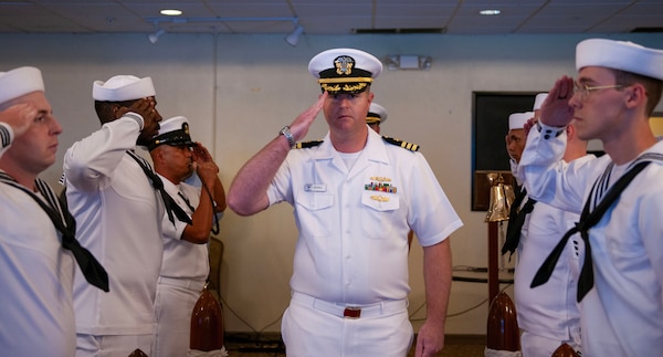 U.S. Navy Cmdr. Anthony Culwell, officer in charge of Naval Information Warfare Center (NIWC) Pacific’s Guam detachment, exchanges salutes with sideboys during the arrival of the official party for the NIWC Activity Facility Pacific Guam change of charge at Top O' the Mar on Nimitz Hill, Guam, July 12, 2024.