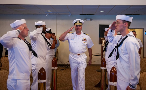 U.S. Navy Capt. Patrick McKenna, commanding officer of Naval Information Warfare Center (NIWC) Pacific, exchanges salutes with sideboys during the arrival of the official party for the NIWC Activity Facility Pacific Guam change of charge at Top O' the Mar on Nimitz Hill, Guam, July 12, 2024.