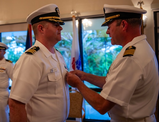 U.S. Navy Capt. Patrick McKenna, commanding officer of Naval Information Warfare Center (NIWC) Pacific, presents Cmdr. Anthony Culwell, officer in charge of NIWC Activity Facility Pacific Guam, the Meritorious Service Medal during the change of charge ceremony at Top O' the Mar on Nimitz Hill, Guam, July 12, 2024.