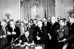 President Johnson signing Civil Rights Act of 1964 with several notable onlookers.