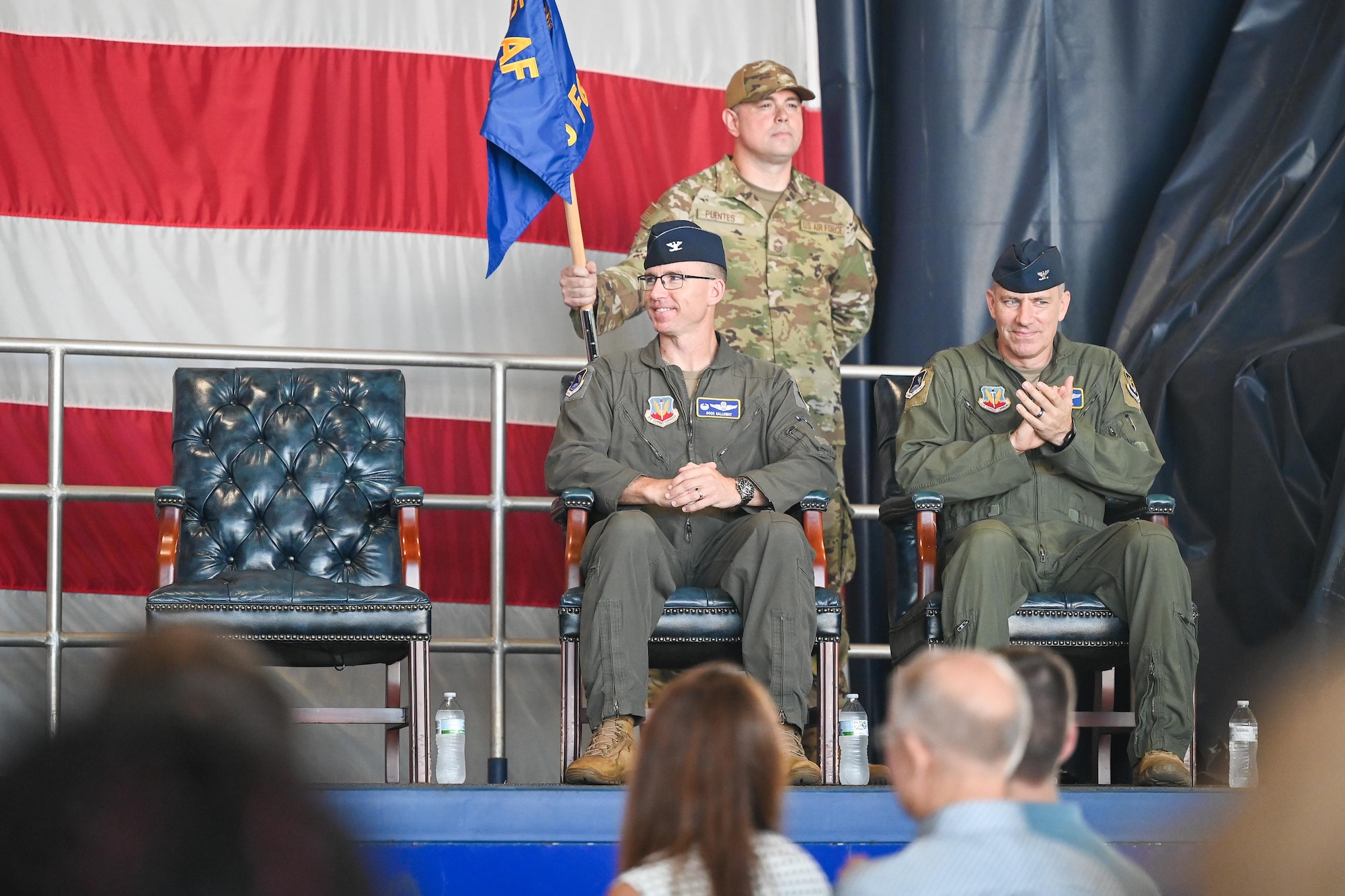 49th FG incoming and outgoing commanders sit on stage.