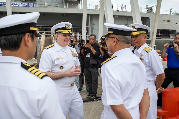 240717-N-WM182-1035 PORT KLANG, Malaysia (July 17, 2024) Vice Adm. Fred Kacher (center), commander, U.S. 7th Fleet, is greeted by senior members of the Royal Malaysian Navy following the arrival of the 7th Fleet flagship USS Blue Ridge (LCC 19) in Port Klang, Malaysia, July 17, 2024. 7th Fleet is the U.S. Navy's largest forward-deployed numbered fleet, and routinely interacts and operates with allies and partners in preserving a free and open Indo-Pacific region. (U.S. Navy Photo by Mass Communication Specialist 2nd Class Caitlin Flynn)