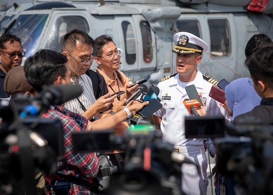 Commanding officer Capt. Nicholas DeLeo answers questions for local media aboard USS Blue Ridge (LCC 19).