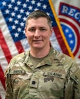 Lt. Col. Sherck poses in front of U.S. Flag