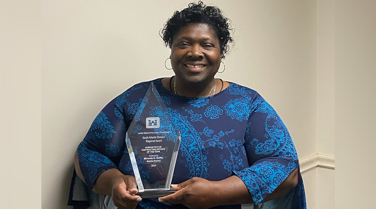 Woman holding an award.