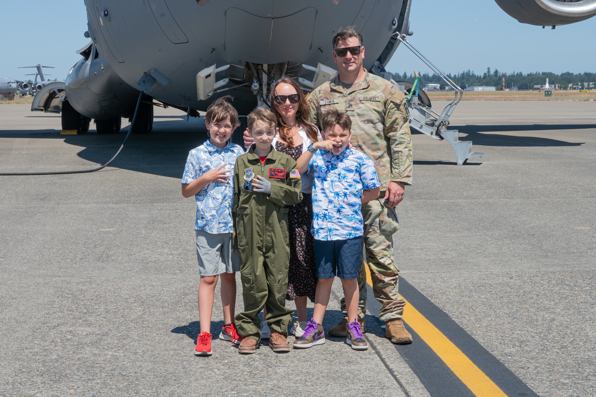 McCoy Cannon, Team McChord’s newest 12-year-old “Pilot for a Day” participant, center left, and his family stand in front of a C-17 Globemaster III at Joint Base Lewis-McChord, Washington, July 11, 2024.