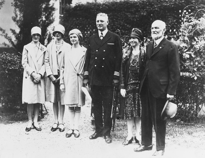 Six people stand in a line to pose for a photo.