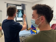 U.S. Army Capt. Peter Lannon, left, a nurse with the Vermont Army National Guard, reviews a patient's X-ray images during a multi-national medical exercise in Kédougou, Senegal, led by the Vermont National Guard on June 6, 2024. The exercise included Airmen and Soldiers with the Vermont and New Hampshire National Guard, medical teams with the Austrian and Senegalese armed forces who all worked alongside hospital teams located locations throughout Senegal.