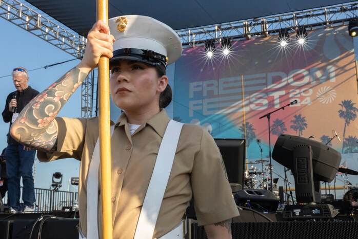 U.S. Marine Corps Sgt. Stephanie Becerra, the Recruiting Station Orange County color sergeant, presents colors during a color guard display for Freedom Fest 2024  in Cerritos, Calif., July 7, 2024. RS Orange County consists of twenty RSSs, Primary Contact Stations and Officer Selection Stations ranging from Los Angeles to Orange County. (U.S. Marine Corps photo by Cpl. Fred Garcia)