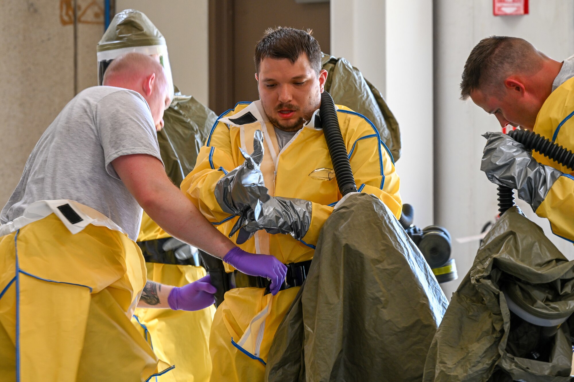 Putting on chemical protection suits