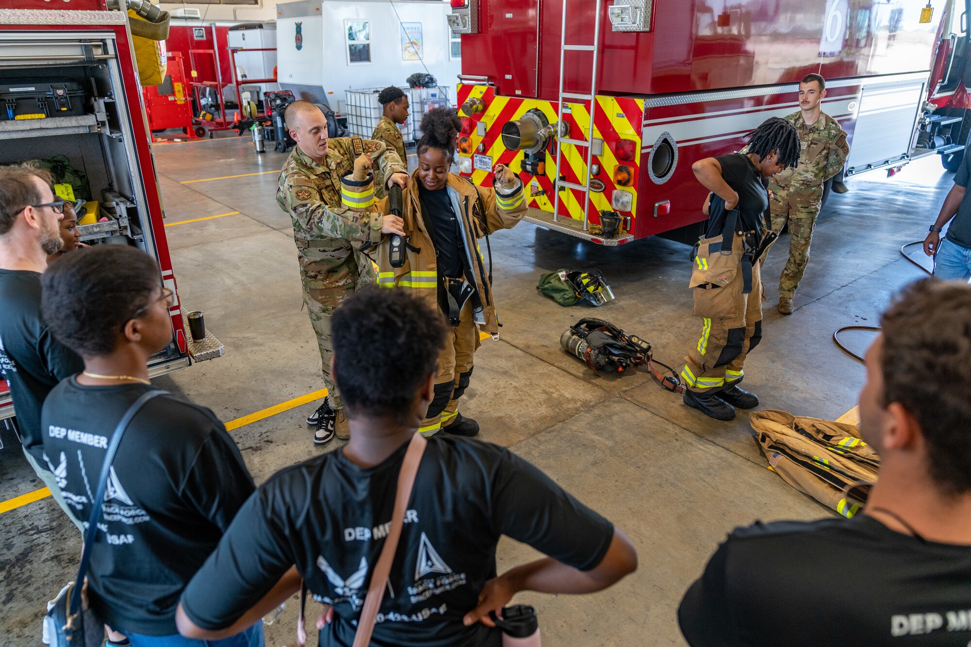 Enlistees assigned to the 331st Recruiting Squadron delayed entry program try on firefighting gear during their tour of Keesler Air Force Base, Mississippi, July 11, 2024. These future Airmen and Guardians received the tour to better understand the various career fields within the Air Force and Space Force.  (U.S. Air Force photo by Andrew Young)