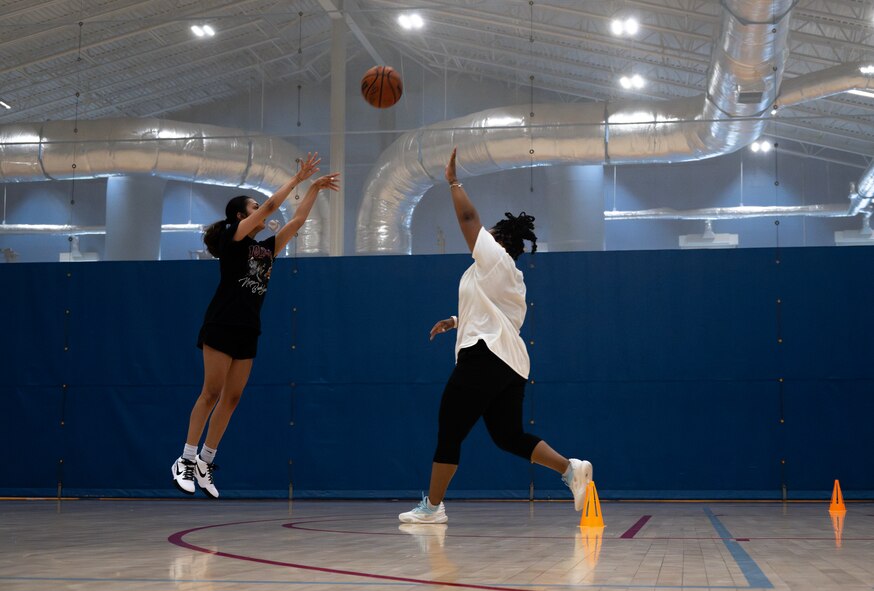 U.S. Air Force Senior Airman Jasmine Arguijo, 5th Force Support Squadron food service apprentice and Lady Bomber, takes a shot at Minot Air Force Base, North Dakota, July 10, 2024. The Lady Bombers play in the Women's Military Basketball Association, which comprises teams from several branches of the armed forces. (U.S. Air Force photo by Airman 1st Class Alyssa Bankston)
