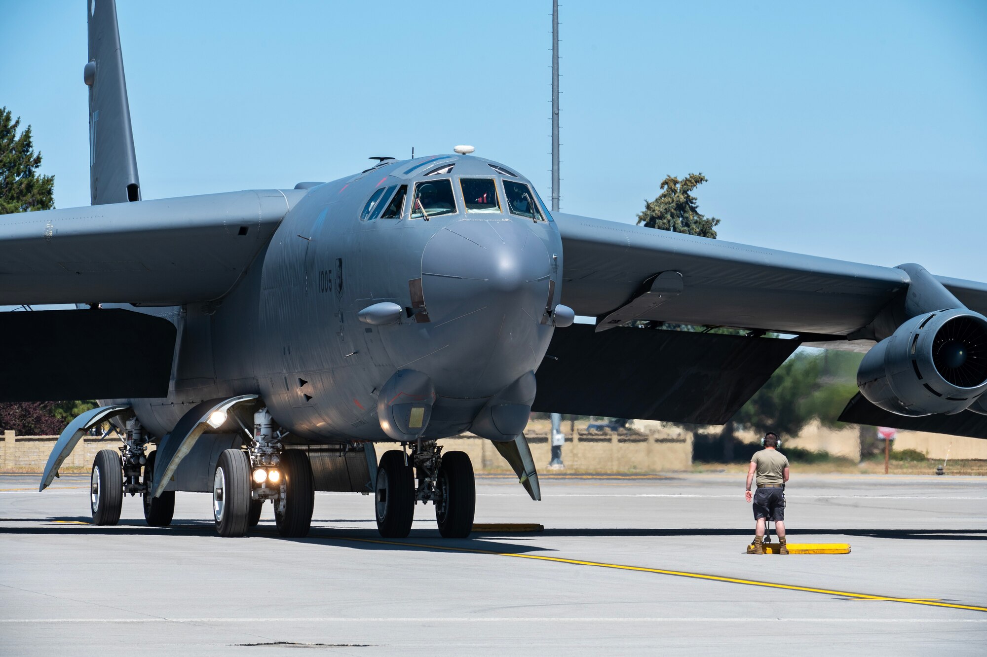 A B-52H Stratofortress assigned to the 69th Bomb Squadron is marshalled at Fairchild Air Force Base, Washington, July 15, 2024. Four B-52’s arrived from Minot AFB to Fairchild AFB for Agile Combat Employment integration event, Agile Warbird. This integration is mutually beneficial between Minot AFB and Fairchild AFB as it grants the B-52 aircrew the ability to operate out of a diverse location, while providing Fairchild Airmen the opportunity to integrate and train with B-52 aircraft and personnel. (U.S. Air Force photo by Senior Airman Morgan St Marks)