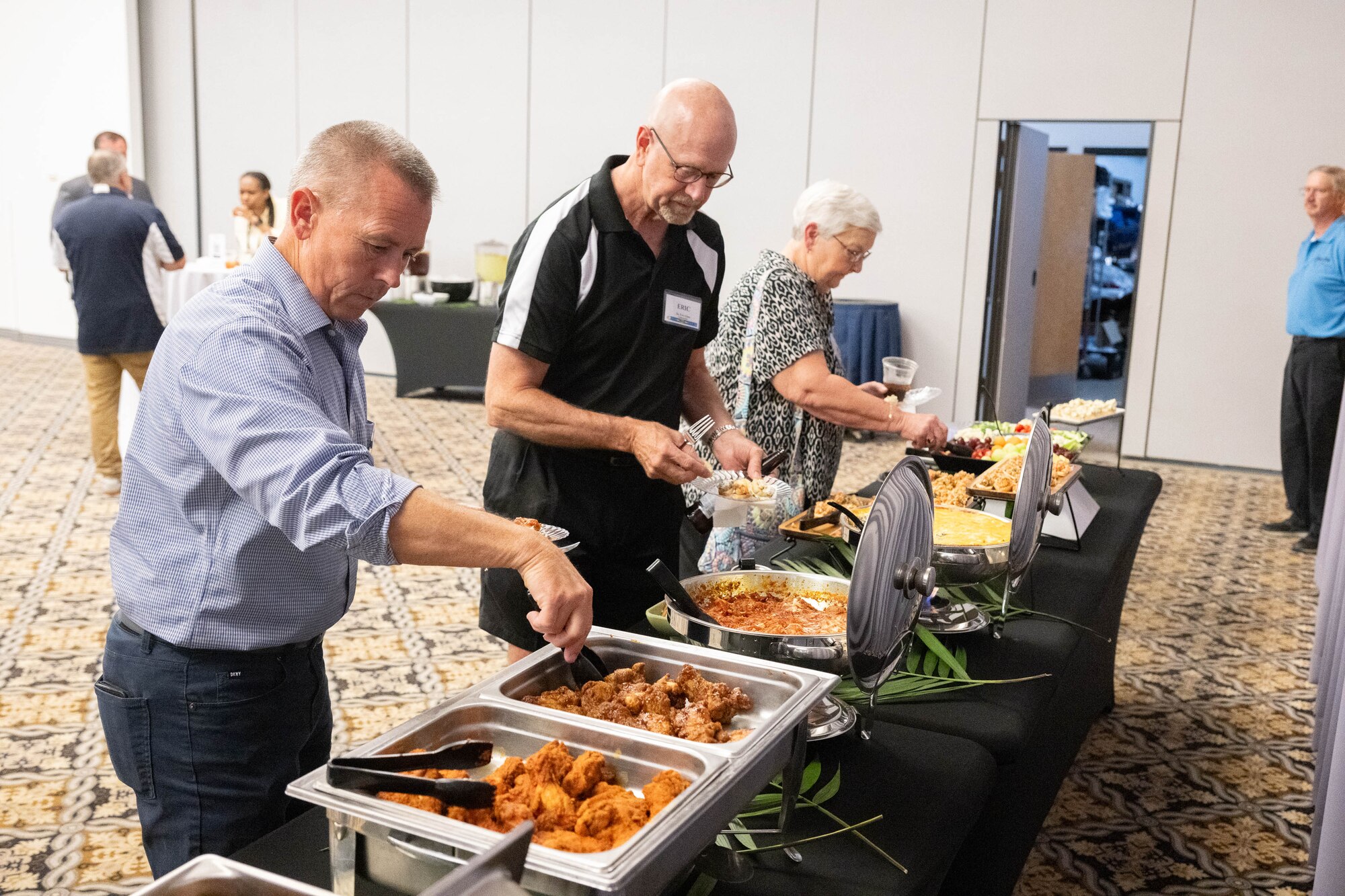 Former Dover Air Force Base honorary commanders enjoy hors d'oeuvres during an Ambassador Program Social at Dover AFB, Delaware, July 16, 2024. The new Ambassador Program aims to facilitate a continued connection between past HCCs and Dover AFB. (U.S. Air Force photo by Mauricio Campino)