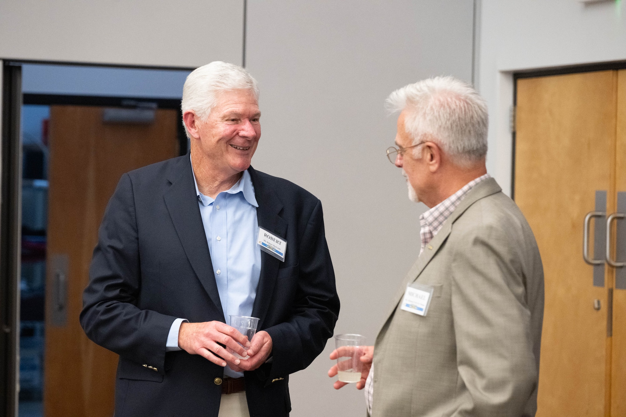 Robert MacLeish and Michael Petit de Mange, former Dover Air Force Base honorary commanders reconnect during an Ambassador Program Social at Dover AFB, Delaware, July 16, 2024. The new Ambassador Program aims to facilitate a continued connection between past HCCs and Dover AFB. (U.S. Air Force photo by Mauricio Campino)