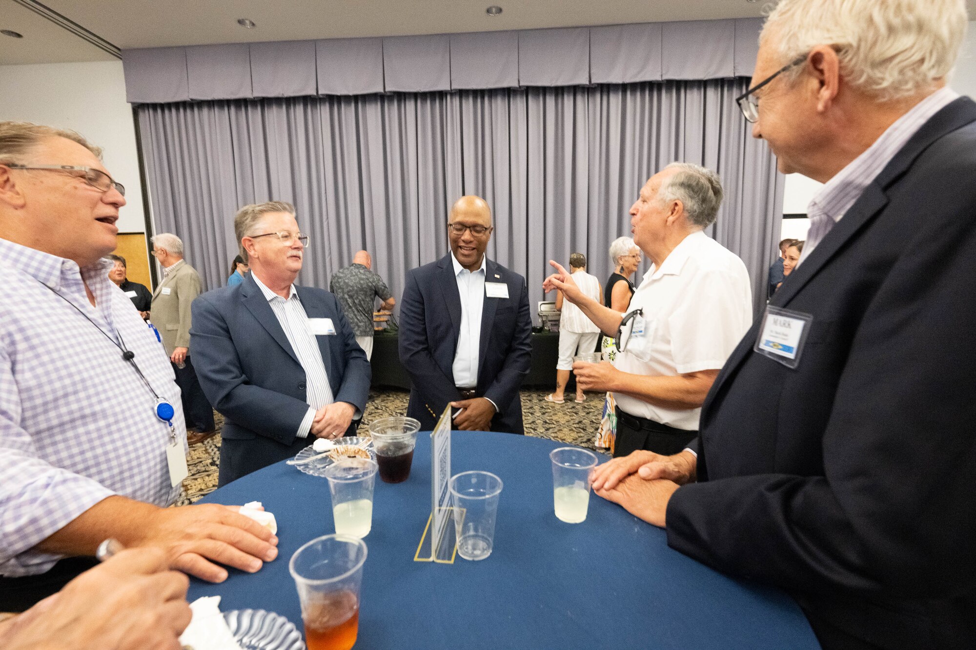 A group of former Dover Air Force Base honorary commanders reconnect during an Ambassador Program Social at Dover AFB, Delaware, July 16, 2024. The new Ambassador Program is designed with a dual purpose to nurture and maintain enduring relationships between past HCCs and Dover AFB and to provide a platform for Ambassadors to serve as mentors to current and aspiring HCCs. (U.S. Air Force photo by Mauricio Campino)