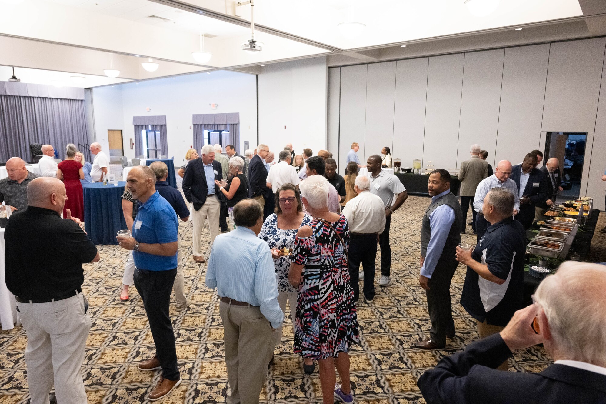 A group of former Dover Air Force Base honorary commanders and base leadership reconnect during an Ambassador Program Social at Dover AFB, Delaware, July 16, 2024. The new Ambassador Program aims to facilitate a continued connection between past HCCs and Dover AFB. (U.S. Air Force photo by Mauricio Campino)