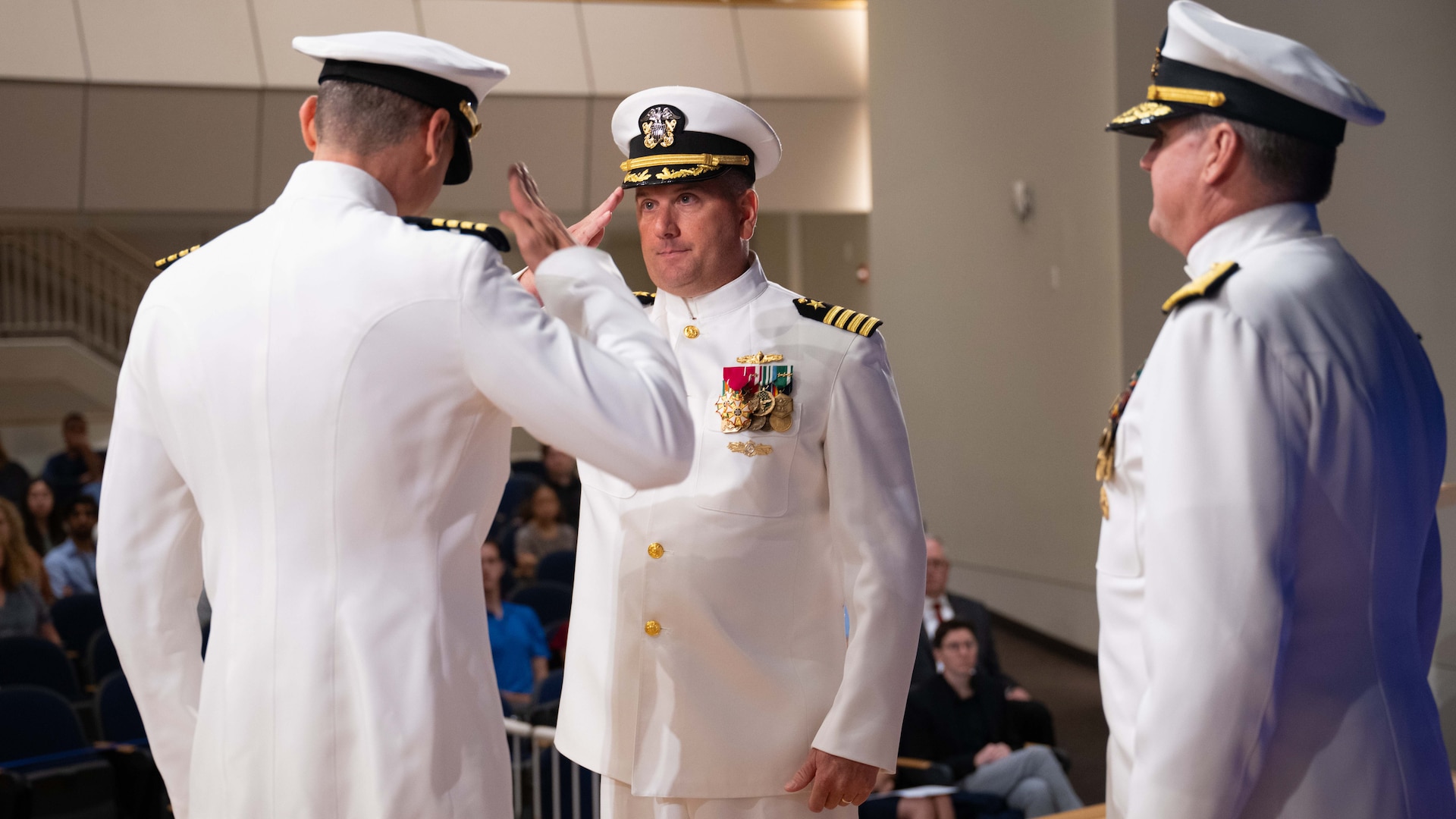 New Carderock Commanding Officer Capt. Christopher Matassa (left) relieves outgoing Commanding Officer Capt. Matthew Tardy (center) of his duties at Naval Surface Warfare Center, Carderock Division in West Bethesda, Md., on July 17, 2024.