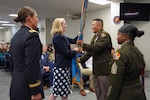 Dr. Katherine Helland, director of Military Accession Policy, passes the USMEPCOM guidon to Army Col. Frankie Cochiaosue, USMEPCOM commander. Cochiaosue assumed command of USMEPCOM, succeeding Army Col. Megan Stallings, during a Change of Command and Retirement Ceremony July 17 at USMEPCOM headquarters in North Chicago, Ill.